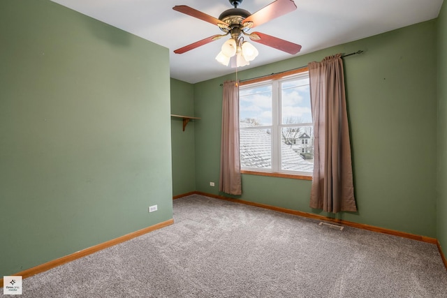 empty room with ceiling fan and carpet flooring