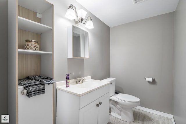 bathroom featuring vanity and toilet