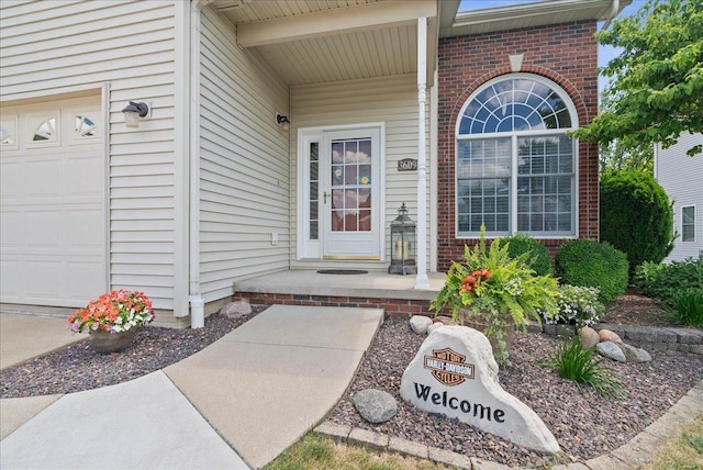 doorway to property with a garage