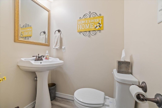 bathroom with wood-type flooring and toilet