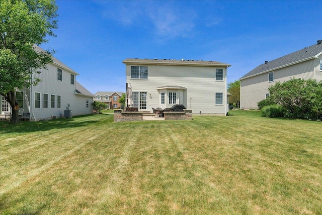 rear view of property with a patio and a yard