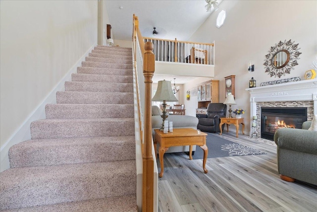 stairway featuring hardwood / wood-style flooring and a towering ceiling