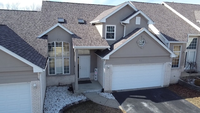646 Aspen Dr, Romeoville, IL 60446 - view of front of property with stucco siding, an attached garage, aphalt driveway, brick siding, and a shingled roof