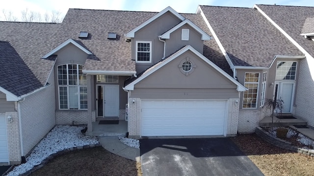 646 Aspen Dr, Romeoville, IL 60446 - view of front of home with driveway, a shingled roof, a garage, and brick siding