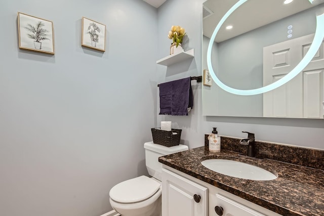 bathroom with vanity and toilet