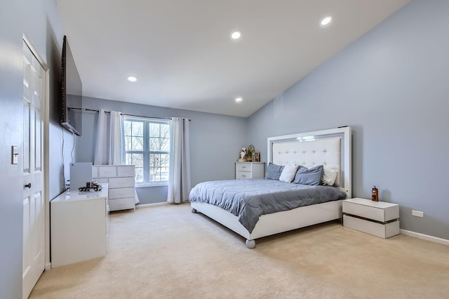 bedroom featuring lofted ceiling and light colored carpet