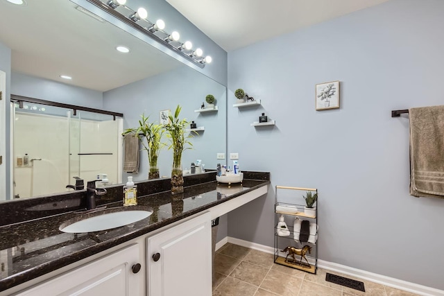 bathroom with vanity, tile patterned floors, and a shower with shower door