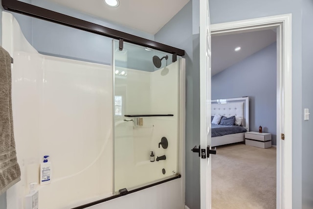 bathroom featuring lofted ceiling and shower / bath combination with glass door