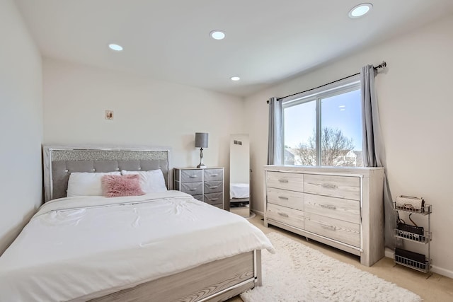 bedroom featuring light carpet