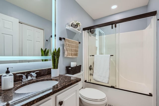 full bathroom with vanity, shower / bath combination with glass door, and toilet