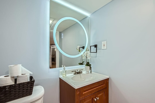 bathroom featuring vanity and toilet