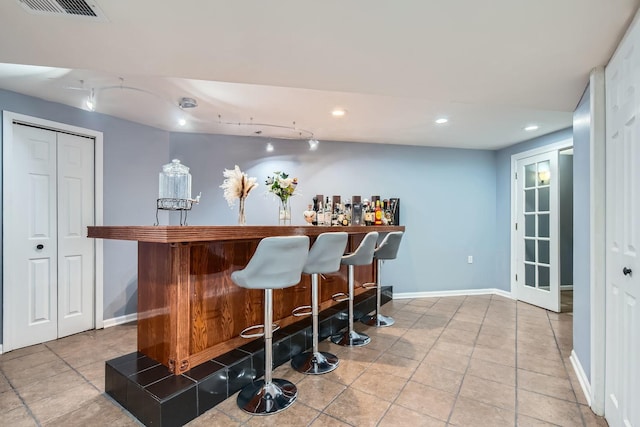 bar featuring tile patterned floors