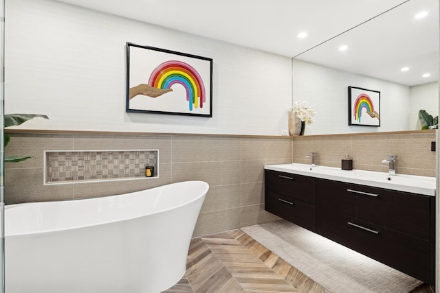 bathroom with parquet flooring, vanity, and a tub