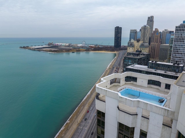 view of swimming pool featuring a water view