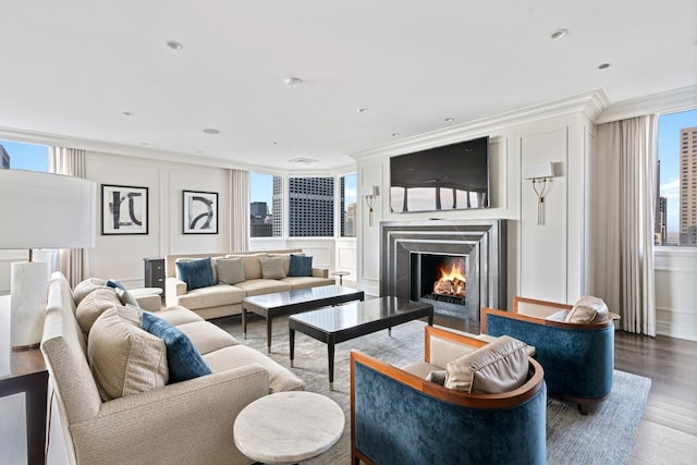 living room featuring ornamental molding and wood-type flooring