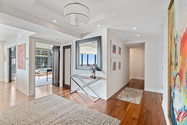 sunroom / solarium with a baseboard heating unit and a water view