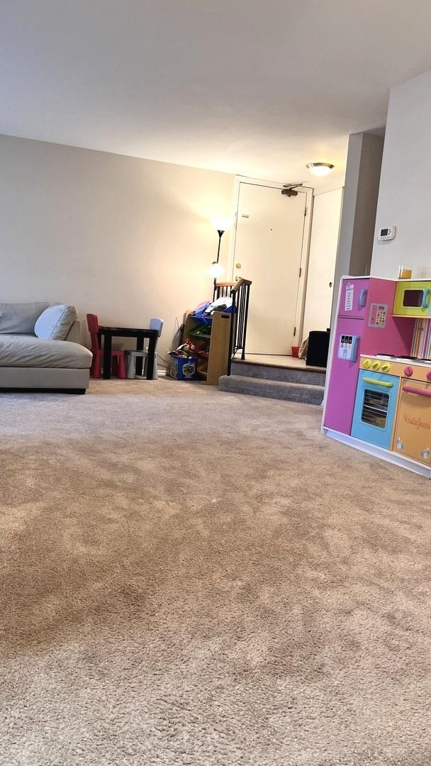 recreation room with carpet flooring