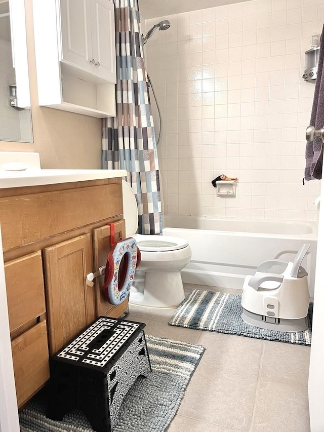 full bathroom with tile patterned flooring, shower / bath combo, vanity, and toilet