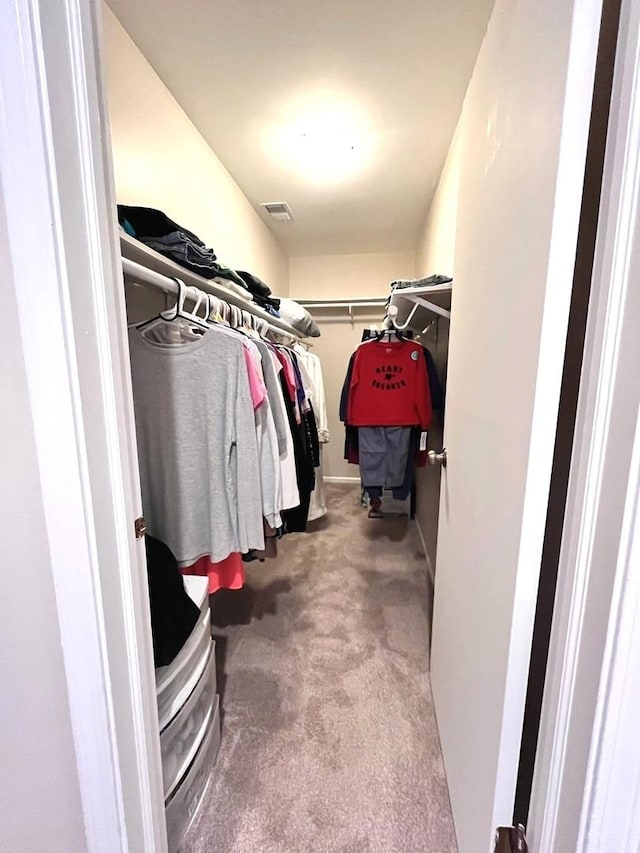 walk in closet featuring carpet