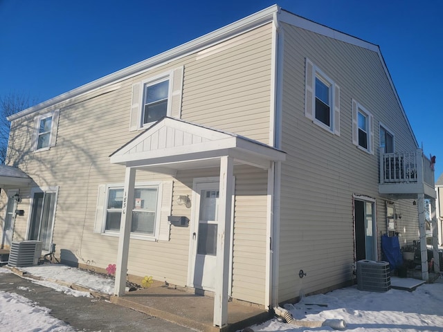 rear view of property featuring central AC unit