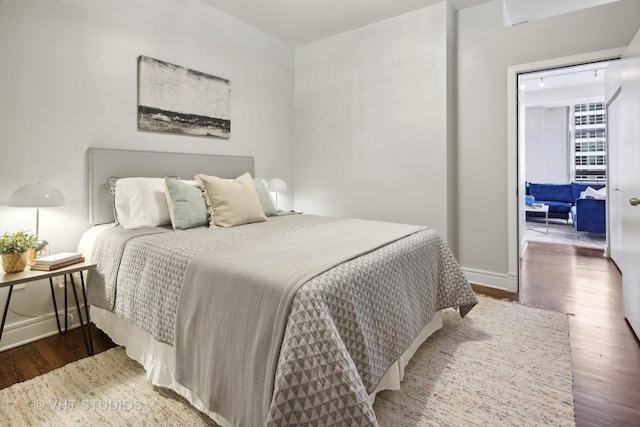 bedroom with dark wood-type flooring