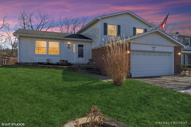 split level home with a garage and a lawn