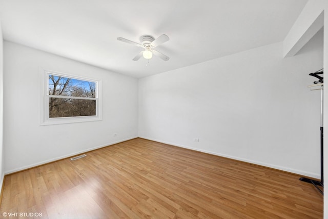 spare room featuring wood-type flooring and ceiling fan