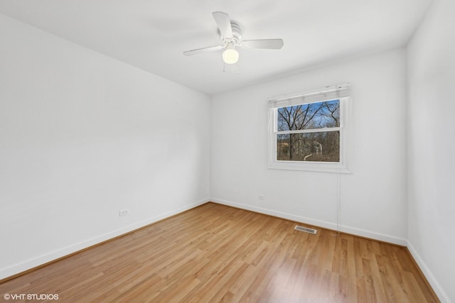 empty room featuring ceiling fan and light hardwood / wood-style floors