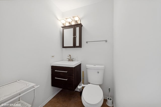 bathroom with vanity, tile patterned floors, and toilet