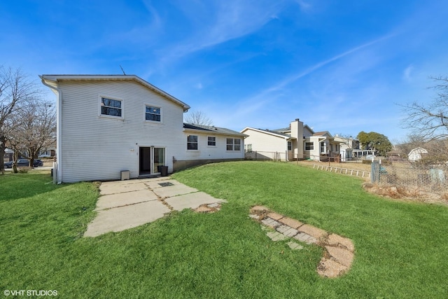 rear view of property with a patio area and a lawn