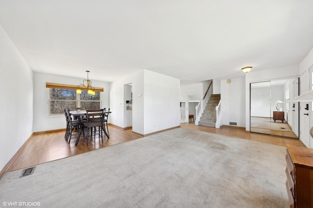 carpeted living room featuring a chandelier