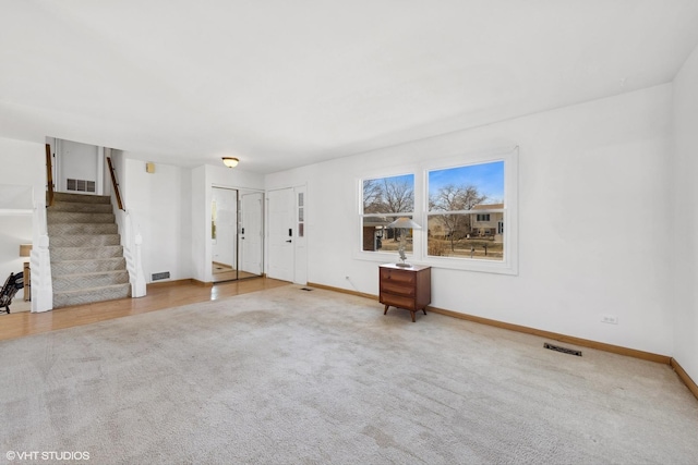 unfurnished living room featuring carpet floors