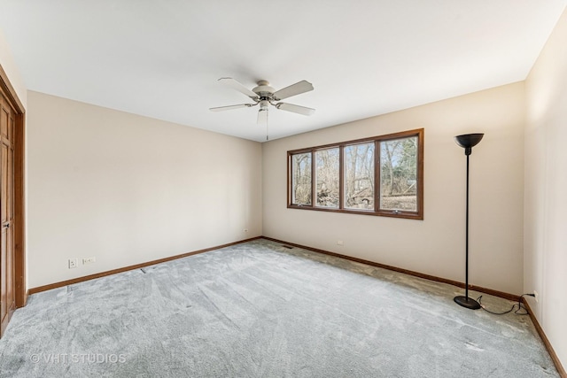 empty room with carpet, baseboards, and ceiling fan