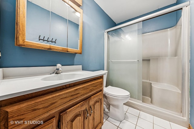 full bathroom with vanity, a shower stall, toilet, and tile patterned floors