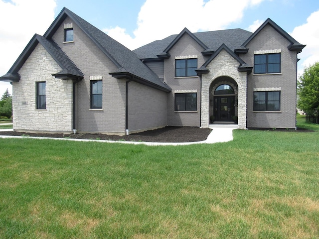 french provincial home featuring a front yard