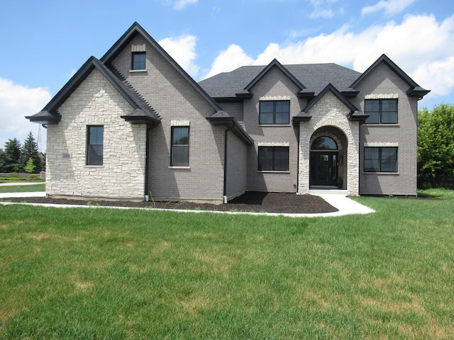 french provincial home featuring a front yard