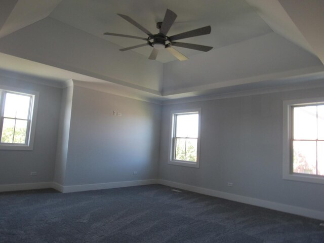 carpeted empty room featuring ceiling fan and a tray ceiling