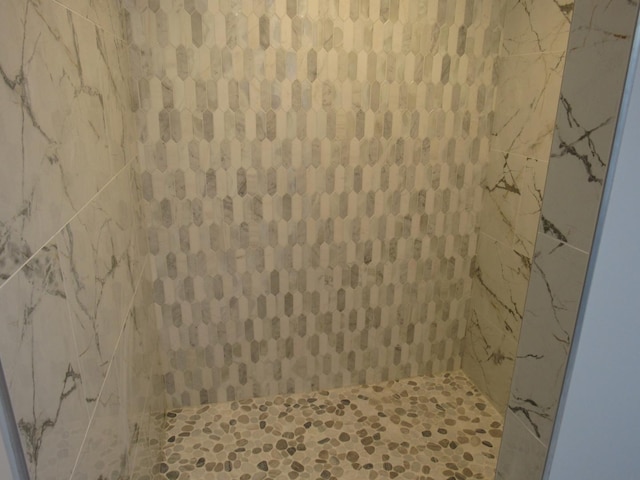 bathroom with tiled shower