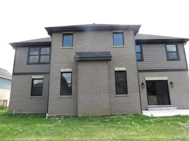 rear view of property featuring a yard