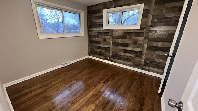 empty room with hardwood / wood-style floors