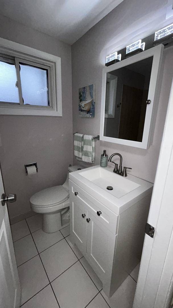 bathroom with tile patterned floors, vanity, and toilet