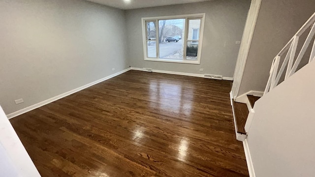 unfurnished room with dark hardwood / wood-style floors