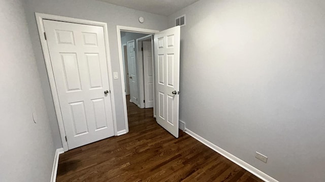 hallway featuring dark hardwood / wood-style flooring