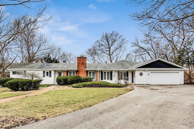 ranch-style home featuring a garage and a front yard