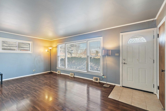 foyer entrance featuring hardwood / wood-style floors and crown molding