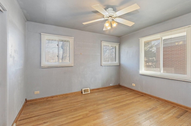 empty room featuring ornamental molding, ceiling fan, and light hardwood / wood-style flooring