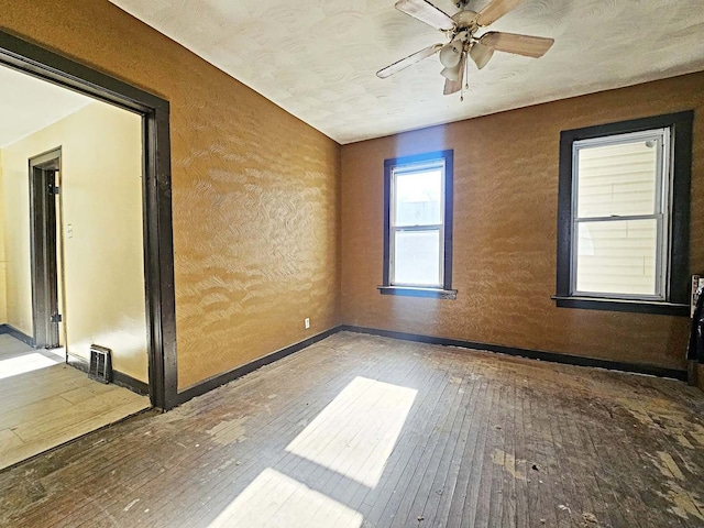 unfurnished room featuring hardwood / wood-style flooring and ceiling fan