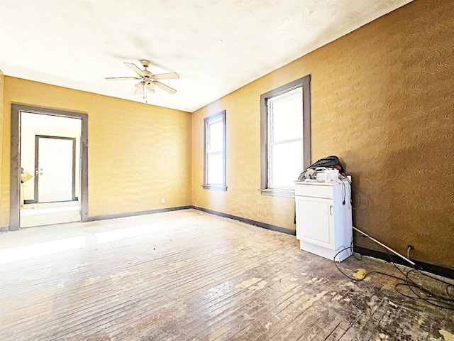 spare room featuring hardwood / wood-style floors and ceiling fan