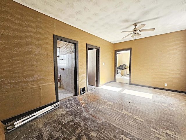 unfurnished room with ceiling fan and wood-type flooring