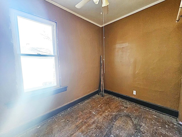 unfurnished room with ornamental molding and ceiling fan